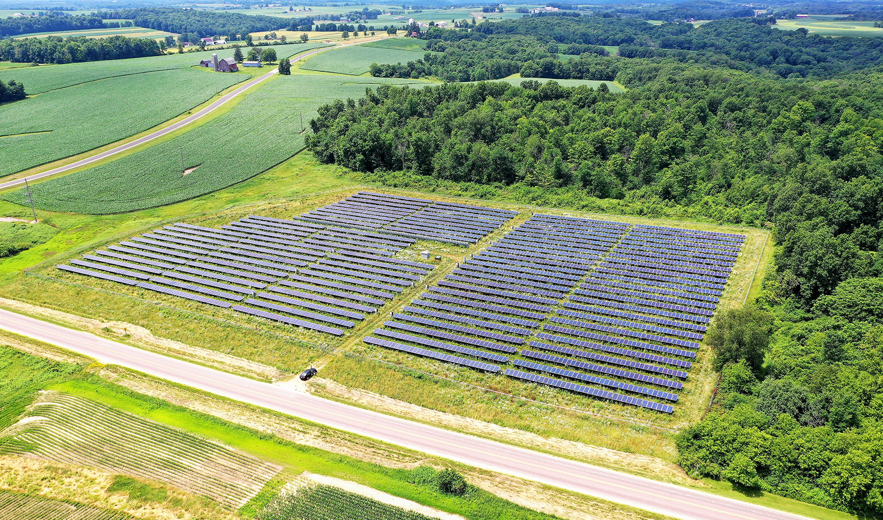 Rows of solar panels in a rustic setting