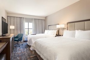 A hotel room with two queen beds.